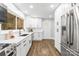 Modern kitchen with white cabinets, stainless steel appliances, and a bright window at 4114 Stacy Blvd, Charlotte, NC 28209