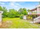 Spacious backyard with lush green grass, shed, and back porch, offering plenty of space to enjoy at 4569 Edgeland Rd, Edgemoor, SC 29712