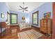 Cozy bedroom featuring blue walls, hardwood floors, natural light and ceiling fan creating a peaceful and inviting retreat at 4569 Edgeland Rd, Edgemoor, SC 29712