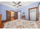 Bright bedroom with hardwood floors, with an inviting quilt on the bed and a doorway leading to the bathroom at 4569 Edgeland Rd, Edgemoor, SC 29712