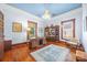 Inviting home office featuring hardwood floors, bright blue ceiling, and custom wood shelving, perfect for a productive workspace at 4569 Edgeland Rd, Edgemoor, SC 29712