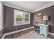 Small home office with large windows offering natural light and an eclectic feel from the paint and furniture combination at 4569 Edgeland Rd, Edgemoor, SC 29712