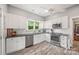 Well-lit kitchen features stainless steel appliances, white cabinetry, and updated countertops at 4569 Edgeland Rd, Edgemoor, SC 29712