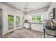 Bright kitchen features white cabinets, stainless steel appliances, and access to an outdoor deck at 4569 Edgeland Rd, Edgemoor, SC 29712