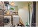 Functional laundry room with a washer, dryer, window and built-in shelving for optimal organization and convenience at 4569 Edgeland Rd, Edgemoor, SC 29712