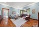 Bright living room showcasing hardwood floors, large windows, comfortable seating, and classic architectural details at 4569 Edgeland Rd, Edgemoor, SC 29712