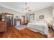 Cozy main bedroom boasts hardwood floors, a ceiling fan, and a decorative fireplace at 4569 Edgeland Rd, Edgemoor, SC 29712
