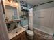 This bathroom features decorative shelves and a bathtub-shower combination, all within a cozy space at 490 Deberry Rd, Mount Gilead, NC 27306