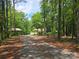 Long driveway with tree cover, that leads to the house and carport at 490 Deberry Rd, Mount Gilead, NC 27306