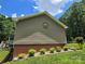 Tan house with brick foundation and lovely manicured landscaping at 490 Deberry Rd, Mount Gilead, NC 27306
