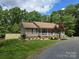 Charming home with a well-maintained yard, a welcoming porch, and an outbuilding on the property at 490 Deberry Rd, Mount Gilead, NC 27306