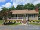 Charming single-story home featuring a welcoming front porch and beautifully landscaped front yard at 490 Deberry Rd, Mount Gilead, NC 27306