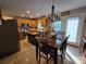 Eat-in kitchen with wood cabinets, stainless steel appliances, a center island, and a dining table set for four at 490 Deberry Rd, Mount Gilead, NC 27306