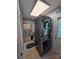 Laundry room featuring a stacked washer and dryer unit, blue walls and tile floor at 490 Deberry Rd, Mount Gilead, NC 27306