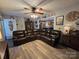Spacious living room with wood-look flooring, a ceiling fan, and a doorway to an eat-in kitchen at 490 Deberry Rd, Mount Gilead, NC 27306