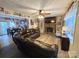 Cozy living room featuring a stone fireplace and a large leather sectional sofa with a view of the dining room at 490 Deberry Rd, Mount Gilead, NC 27306