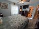 Spacious main bedroom with a TV and an ensuite bathroom for added privacy and convenience at 490 Deberry Rd, Mount Gilead, NC 27306