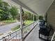 Relaxing porch with seating overlooking the picturesque front yard and tree lined road at 490 Deberry Rd, Mount Gilead, NC 27306