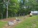 A beautiful yard featuring a greenhouse and propane tank at 490 Deberry Rd, Mount Gilead, NC 27306