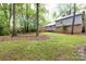 Home's expansive backyard has mature trees and a wood deck at 509 Selkirk Pl, Charlotte, NC 28270