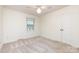 This bedroom features neutral walls, neutral carpet, double closets and a window, offering a versatile space at 509 Selkirk Pl, Charlotte, NC 28270
