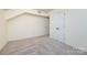 This room features neutral walls and carpet and a double door closet at 509 Selkirk Pl, Charlotte, NC 28270