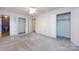 Spacious bedroom with neutral walls, carpet, and multiple closets offering ample storage solutions at 509 Selkirk Pl, Charlotte, NC 28270