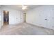 Spacious bedroom with neutral walls, neutral carpet, and multiple closets offering ample storage solutions at 509 Selkirk Pl, Charlotte, NC 28270