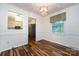 A sunlit dining room with hardwood floors and a view into the kitchen at 509 Selkirk Pl, Charlotte, NC 28270