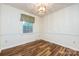 Dining room boasts hardwood floors, chair railing and modern light fixture at 509 Selkirk Pl, Charlotte, NC 28270