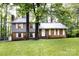 Charming two-story home with brick and siding exterior, surrounded by lush trees and greenery at 509 Selkirk Pl, Charlotte, NC 28270