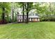 Inviting two-story home with brick and siding exterior, nestled among mature trees and a green lawn at 509 Selkirk Pl, Charlotte, NC 28270