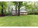 Well-maintained two-story house with a lush green lawn and mature trees, creating a serene and inviting atmosphere at 509 Selkirk Pl, Charlotte, NC 28270