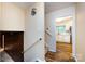 Neutral hallway featuring hardwood flooring, offering access to the kitchen at 509 Selkirk Pl, Charlotte, NC 28270