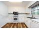 Bright kitchen has white cabinets and modern appliances at 509 Selkirk Pl, Charlotte, NC 28270