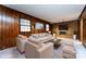 Staged living room featuring a wood panel wall, brick fireplace and seating at 509 Selkirk Pl, Charlotte, NC 28270