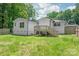 Spacious backyard view showcasing a wooden deck with stairs and ample green space at 518 Westside Cir, China Grove, NC 28023
