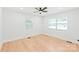 Bright bedroom with hardwood floors, ceiling fan, and plenty of natural light from two windows at 518 Westside Cir, China Grove, NC 28023