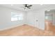 Well-lit bedroom featuring light hardwood floors, and a ceiling fan adjacent to doorway at 518 Westside Cir, China Grove, NC 28023