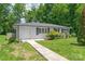 Charming white brick ranch-style home with black shutters and a well-maintained front yard and walkway at 518 Westside Cir, China Grove, NC 28023
