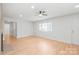 Light-filled living room boasts ceiling fan, white walls, and new floors at 518 Westside Cir, China Grove, NC 28023