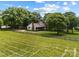 An aerial view of the property showcases the home, fenced yard, and surrounding greenery at 5200 Winding Ln, Indian Trail, NC 28079