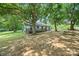 Lush backyard featuring a large deck, mature trees, and ample space for outdoor activities at 5200 Winding Ln, Indian Trail, NC 28079