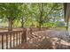 Expansive wooden deck surrounded by mature trees, perfect for outdoor entertaining and relaxation at 5200 Winding Ln, Indian Trail, NC 28079