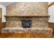 Close-up of a large stone fireplace featuring a black iron grate and stone hearth at 5200 Winding Ln, Indian Trail, NC 28079