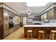 Spacious kitchen featuring wood cabinets, a wooden floor, and modern appliances for an updated look at 5200 Winding Ln, Indian Trail, NC 28079