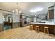 Open kitchen with breakfast bar, wood cabinets, updated appliances, and seamless flow to dining area at 5200 Winding Ln, Indian Trail, NC 28079