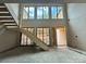 View of the staircase with large windows providing natural light to the open space at 5427 Addison Dr, Charlotte, NC 28211