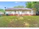 Spacious backyard with a lush lawn, brick foundation, and plenty of natural light at 6216 Bandy Dr, Charlotte, NC 28227