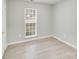 Neutral bedroom filled with natural light, a double-hung window, and modern vinyl flooring at 6216 Bandy Dr, Charlotte, NC 28227